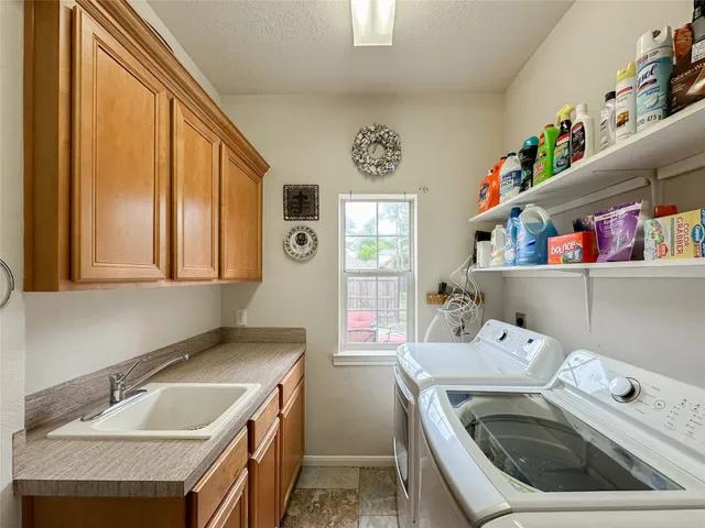 a utility room with a sink a washer and dryer