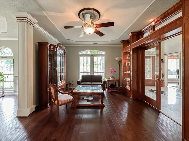 a living room with furniture and wooden floor