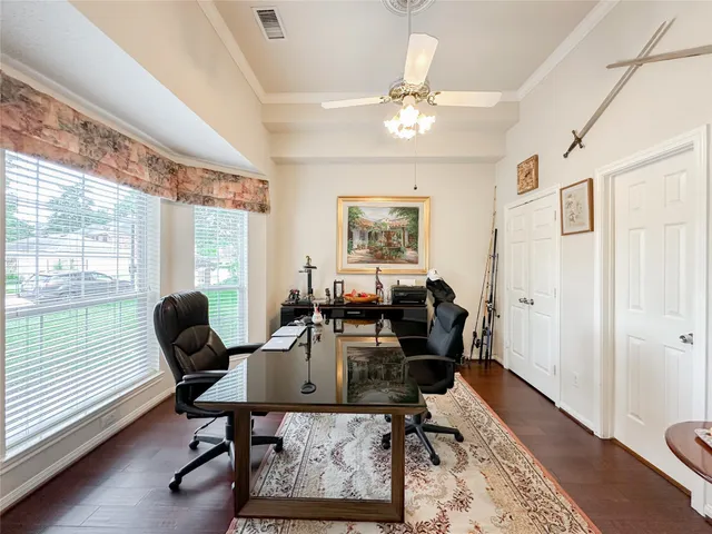 a workspace with wooden floor and a window