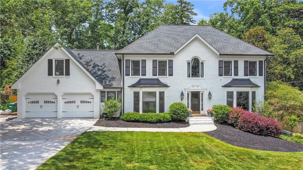 7010 Hunters Knoll Northeast Atlanta, GA 30328 - Photo 1 of 1 a view of a yard in front of house