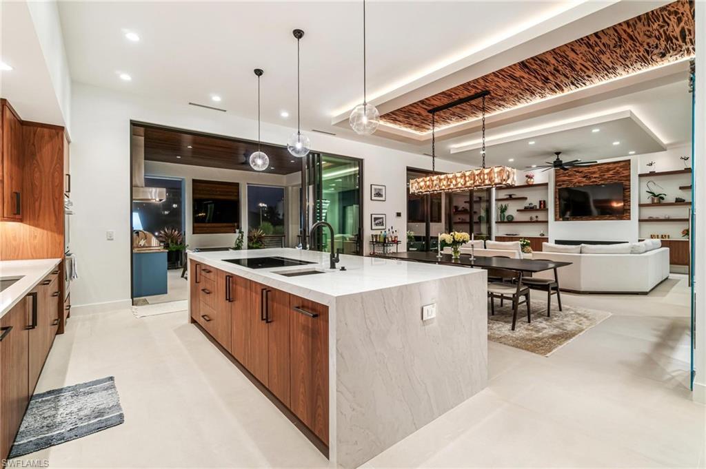 448 Oak Avenue Naples, FL 34108 - Photo 22 of 49 Kitchen featuring a large island, oven, pendant lighting, light tile patterned floors, and sink