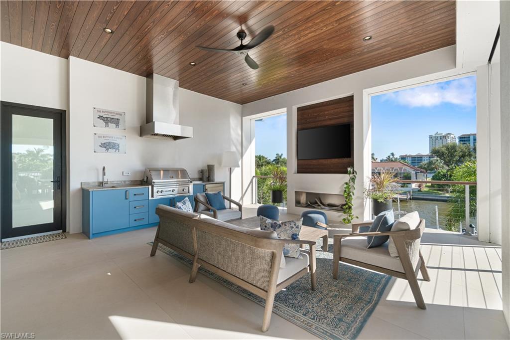 448 Oak Avenue Naples, FL 34108 - Photo 24 of 49 Patio terrace at dusk featuring an outdoor living space