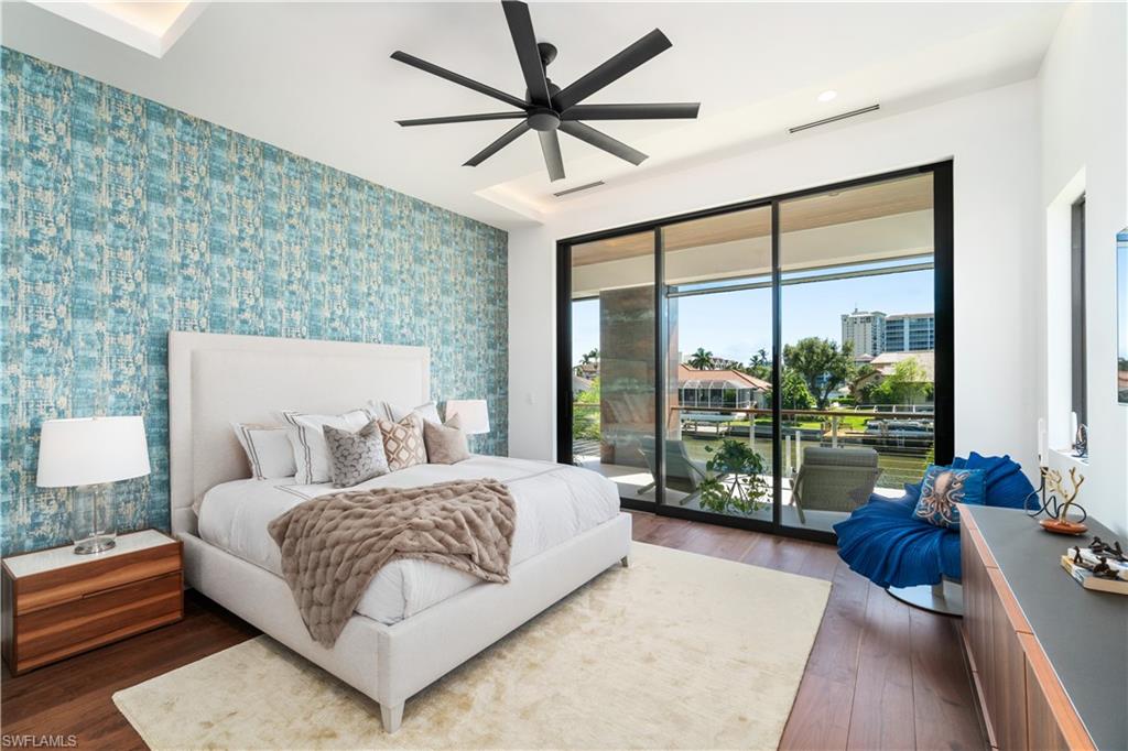 448 Oak Avenue Naples, FL 34108 - Photo 27 of 49 Bedroom with ceiling fan, access to exterior, and dark hardwood / wood-style floors