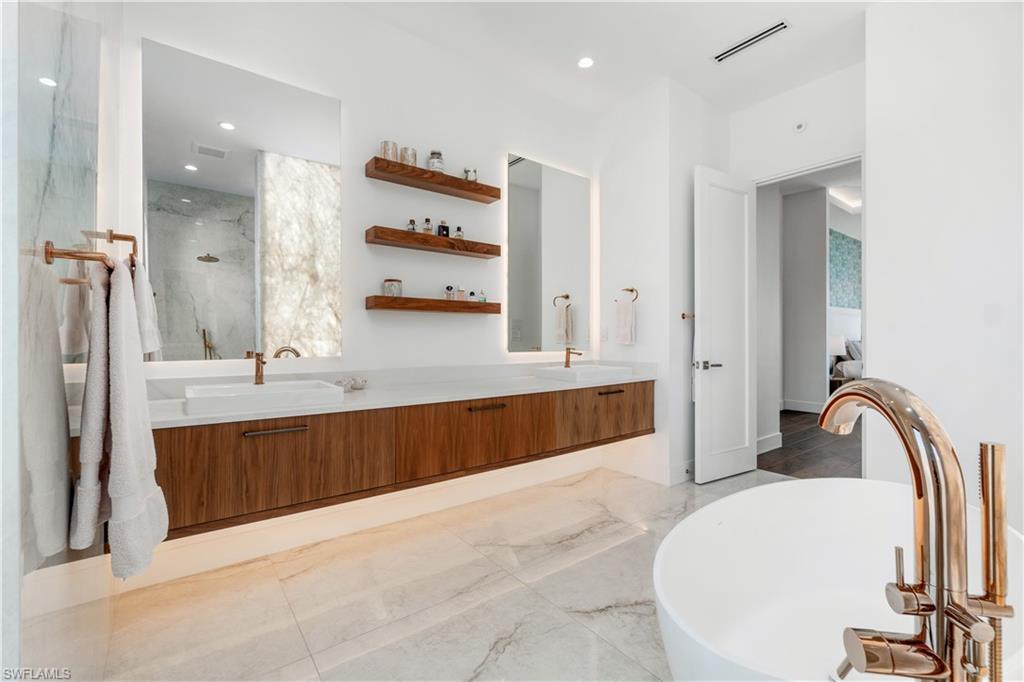 448 Oak Avenue Naples, FL 34108 - Photo 30 of 49 Bathroom with dual vanity, tile patterned floors, and tile walls