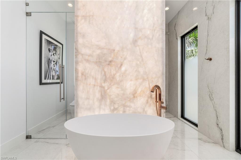 448 Oak Avenue Naples, FL 34108 - Photo 31 of 49 Bathroom with tile patterned floors, double sink vanity, and separate shower and tub