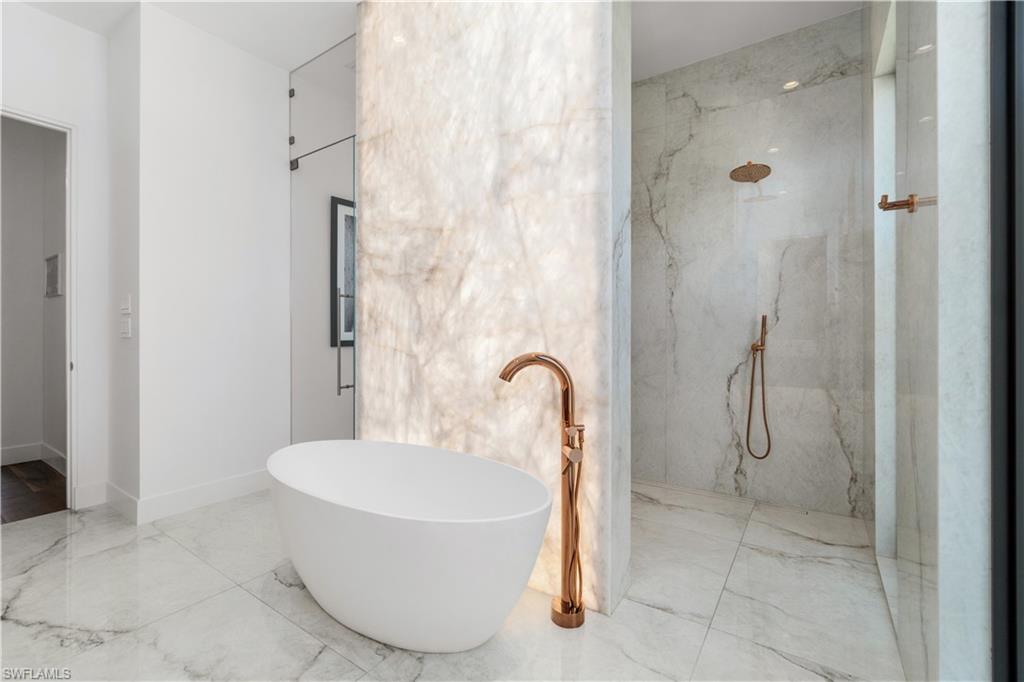 448 Oak Avenue Naples, FL 34108 - Photo 32 of 49 Bathroom featuring toilet, tile patterned floors, and a bathing tub