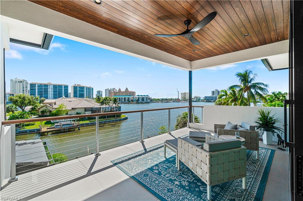 448 Oak Avenue Naples, FL 34108 - Photo 40 of 49 Living room with ceiling fan, a water view, hardwood / wood-style flooring, and a healthy amount of sunlight