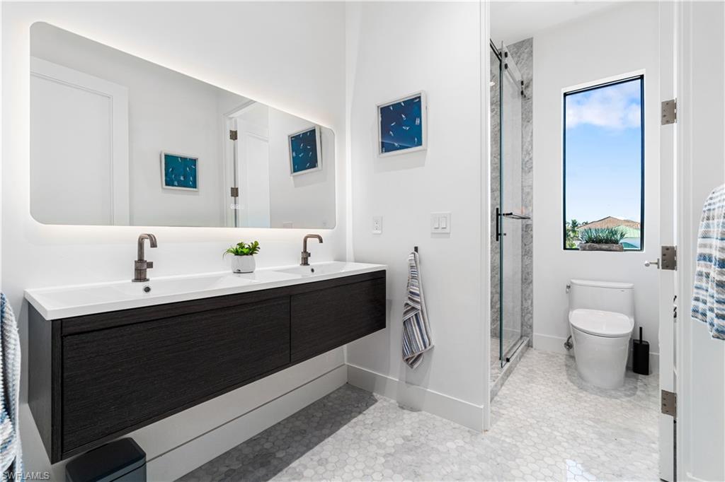 448 Oak Avenue Naples, FL 34108 - Photo 45 of 49 Bedroom featuring dark wood-type flooring and a water view