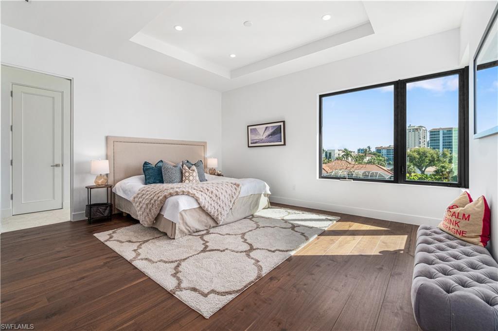 448 Oak Avenue Naples, FL 34108 - Photo 46 of 49 Bathroom with dual vanity, toilet, tile patterned floors, and a shower with shower door