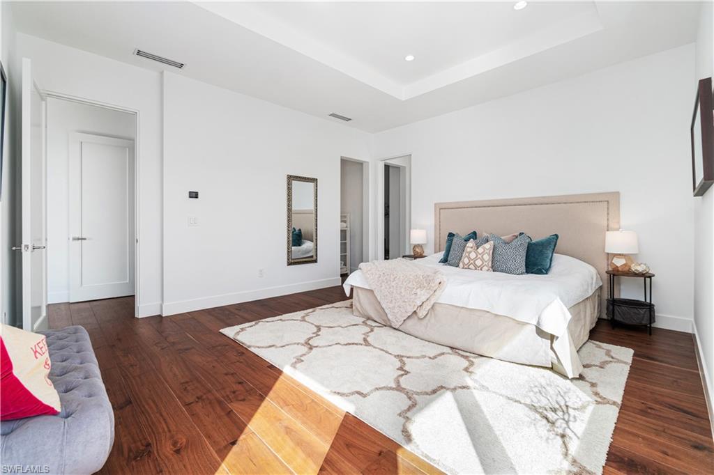 448 Oak Avenue Naples, FL 34108 - Photo 47 of 49 Bedroom with hardwood / wood-style floors and a tray ceiling