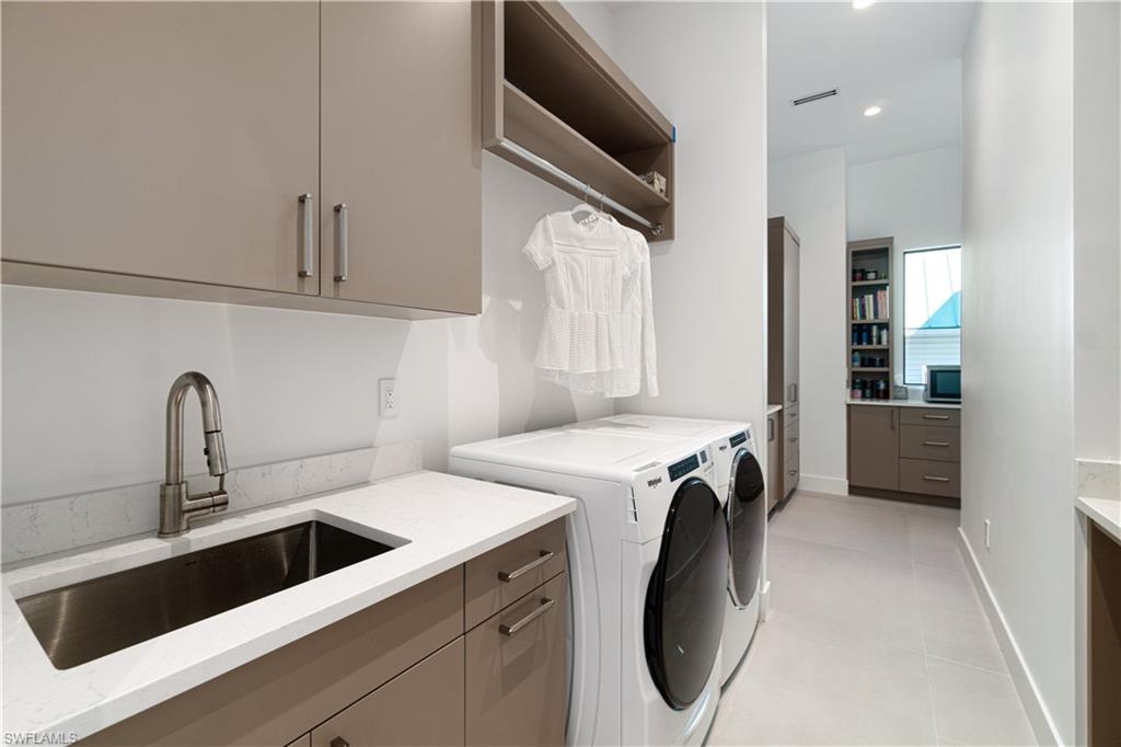 448 Oak Avenue Naples, FL 34108 - Photo 49 of 49 Bathroom featuring double sink vanity, a tile shower, and tile patterned flooring
