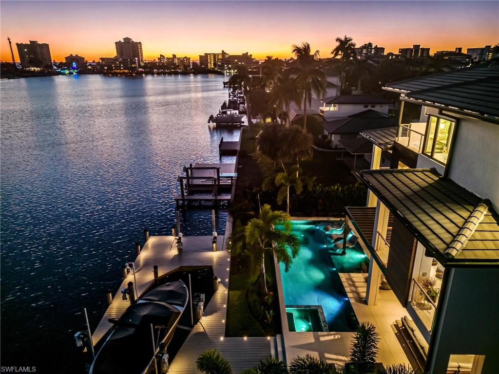 448 Oak Avenue Naples, FL 34108 - Photo 6 of 49 View of swimming pool featuring a water view and a boat dock