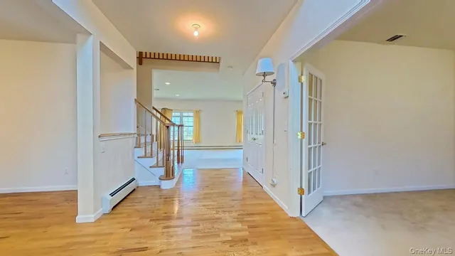 a view of an entryway with wooden floor