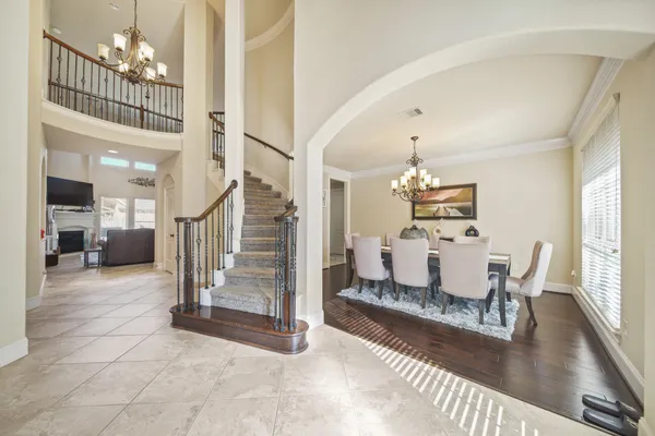 a dining room with furniture entryway and wooden floor