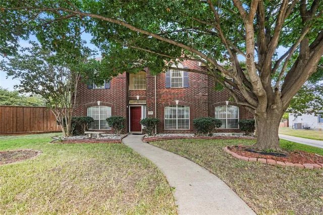 a view of a house with a yard and sitting area