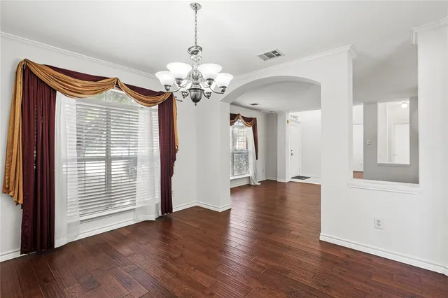 a view of a livingroom with wooden floor and a ceiling fan