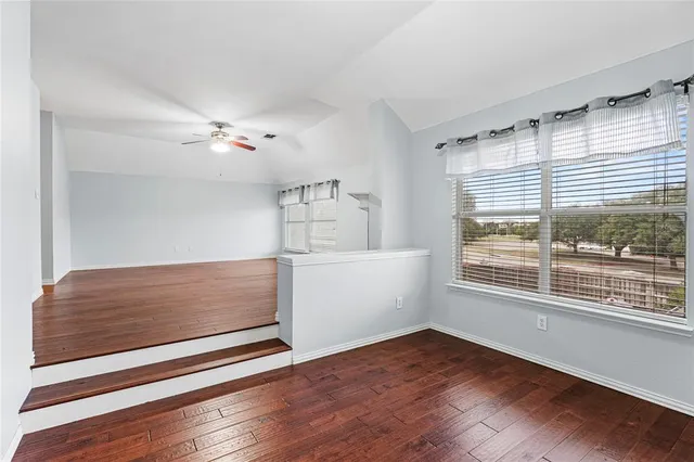 a view of room with window and wooden floor