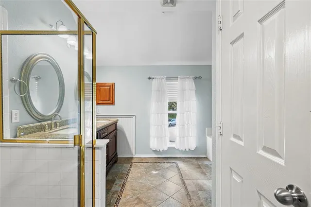 a bathroom with a sink a mirror and a shower