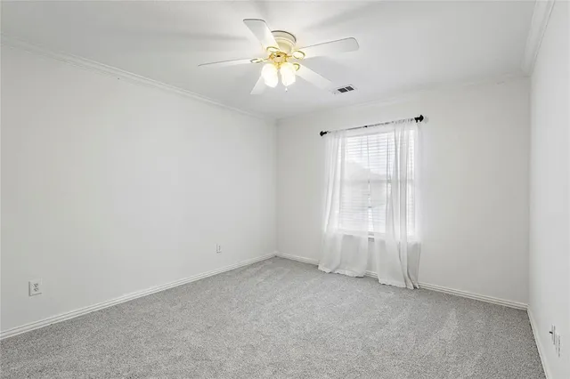 an empty room with closet and windows