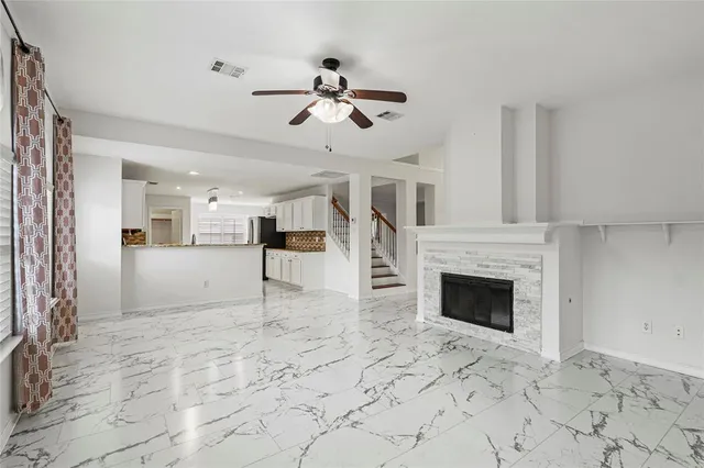 a view of empty room with a fireplace and wooden floor