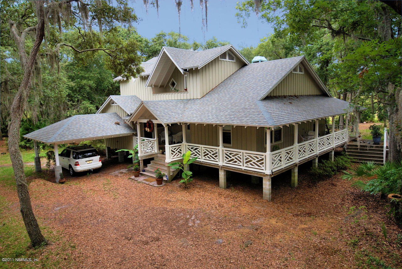 an aerial view of a house with roof deck and barbeque area