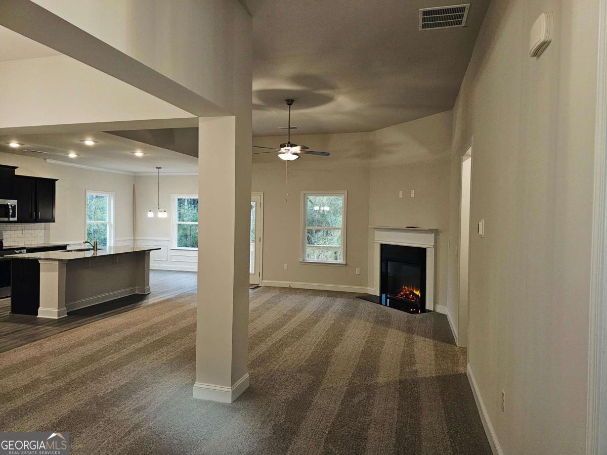 216 Rhett Drive, Unit 12 Bowdon, GA 30108 - Photo 3 of 10 a view of kitchen with fireplace and wooden floor