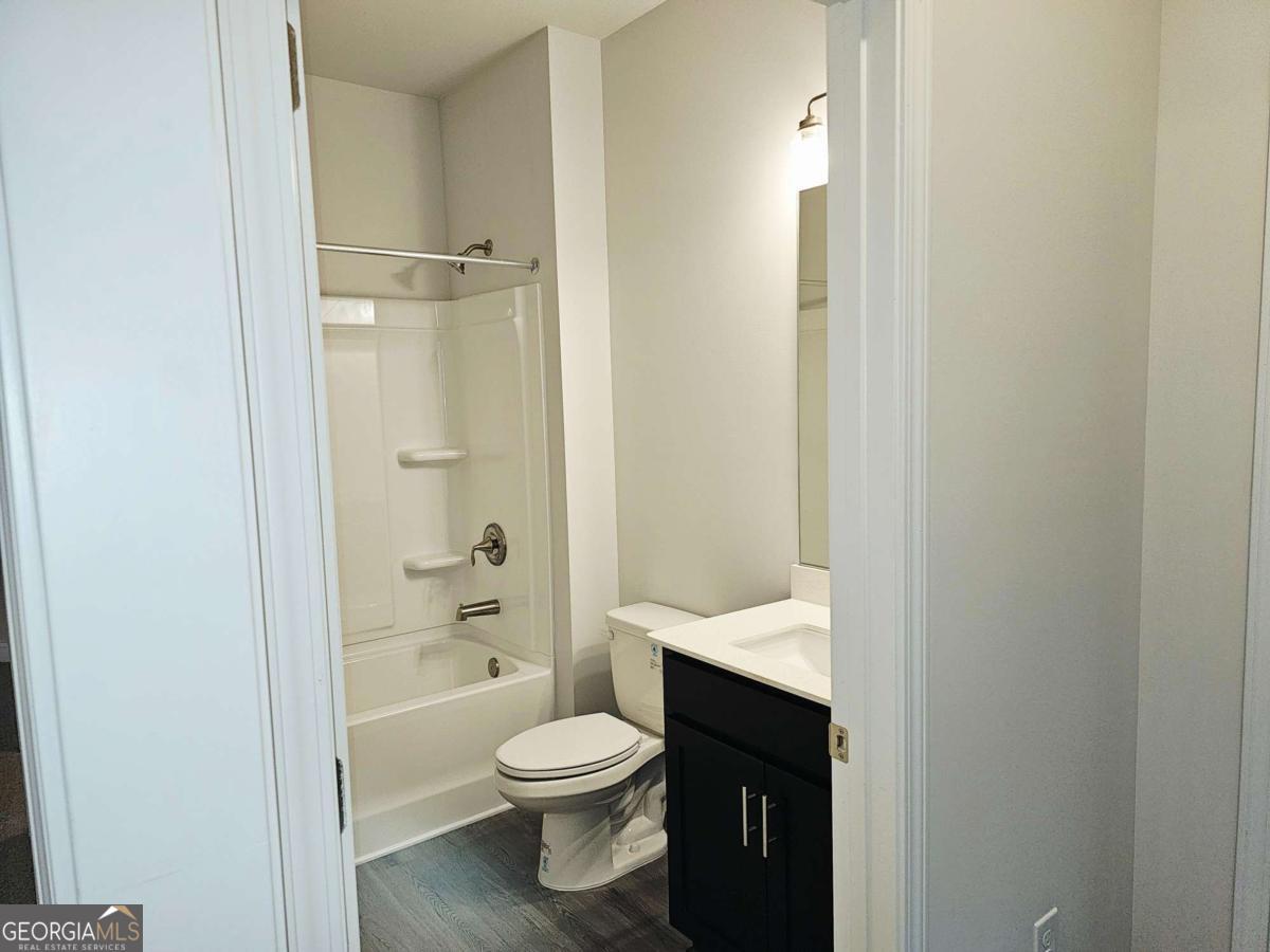 216 Rhett Drive, Unit 12 Bowdon, GA 30108 - Photo 4 of 10 a bathroom with a toilet a sink and shower