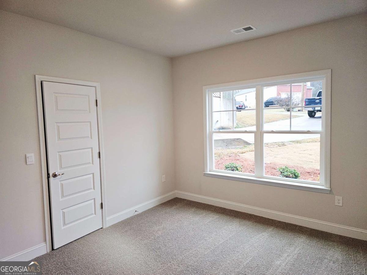 216 Rhett Drive, Unit 12 Bowdon, GA 30108 - Photo 5 of 10 an empty room with a window