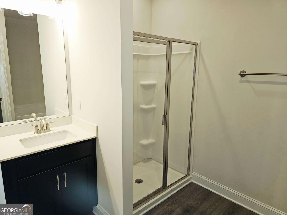 216 Rhett Drive, Unit 12 Bowdon, GA 30108 - Photo 8 of 10 a bathroom with a shower sink and mirror
