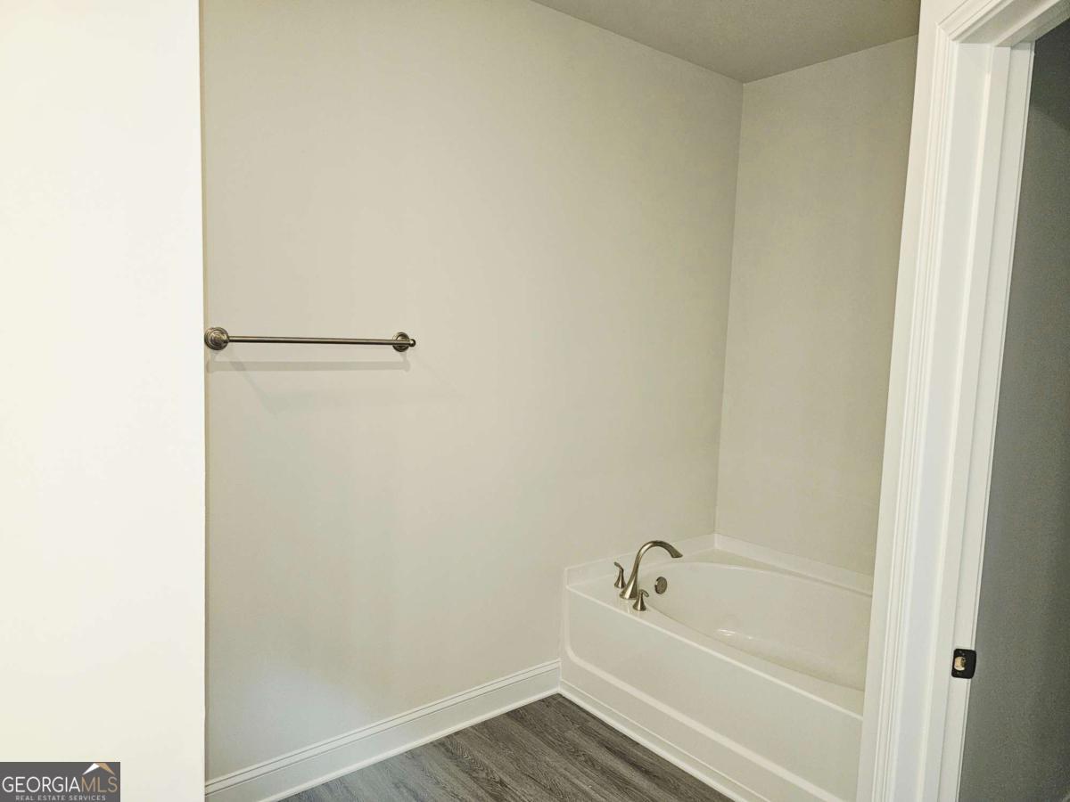 216 Rhett Drive, Unit 12 Bowdon, GA 30108 - Photo 9 of 10 a bathroom with a bathtub