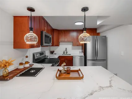 a kitchen with a refrigerator a microwave a stove and cabinets