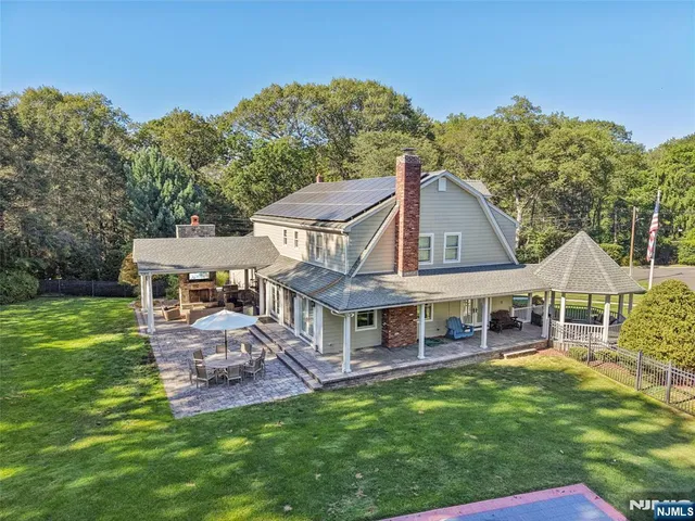 a aerial view of a house with a yard table and chairs