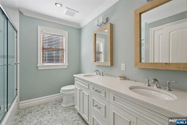 a bathroom with a sink toilet and mirror