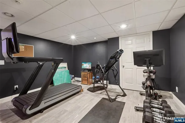 a room with gym equipment and a flat screen tv