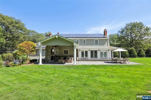 a view of a house with a big yard and potted plants