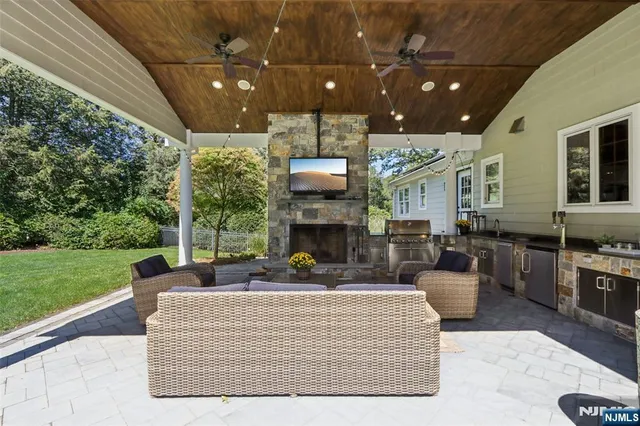 a living room with fireplace furniture and a garden