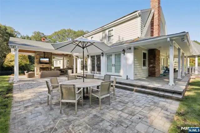 a view of a patio with table and chairs