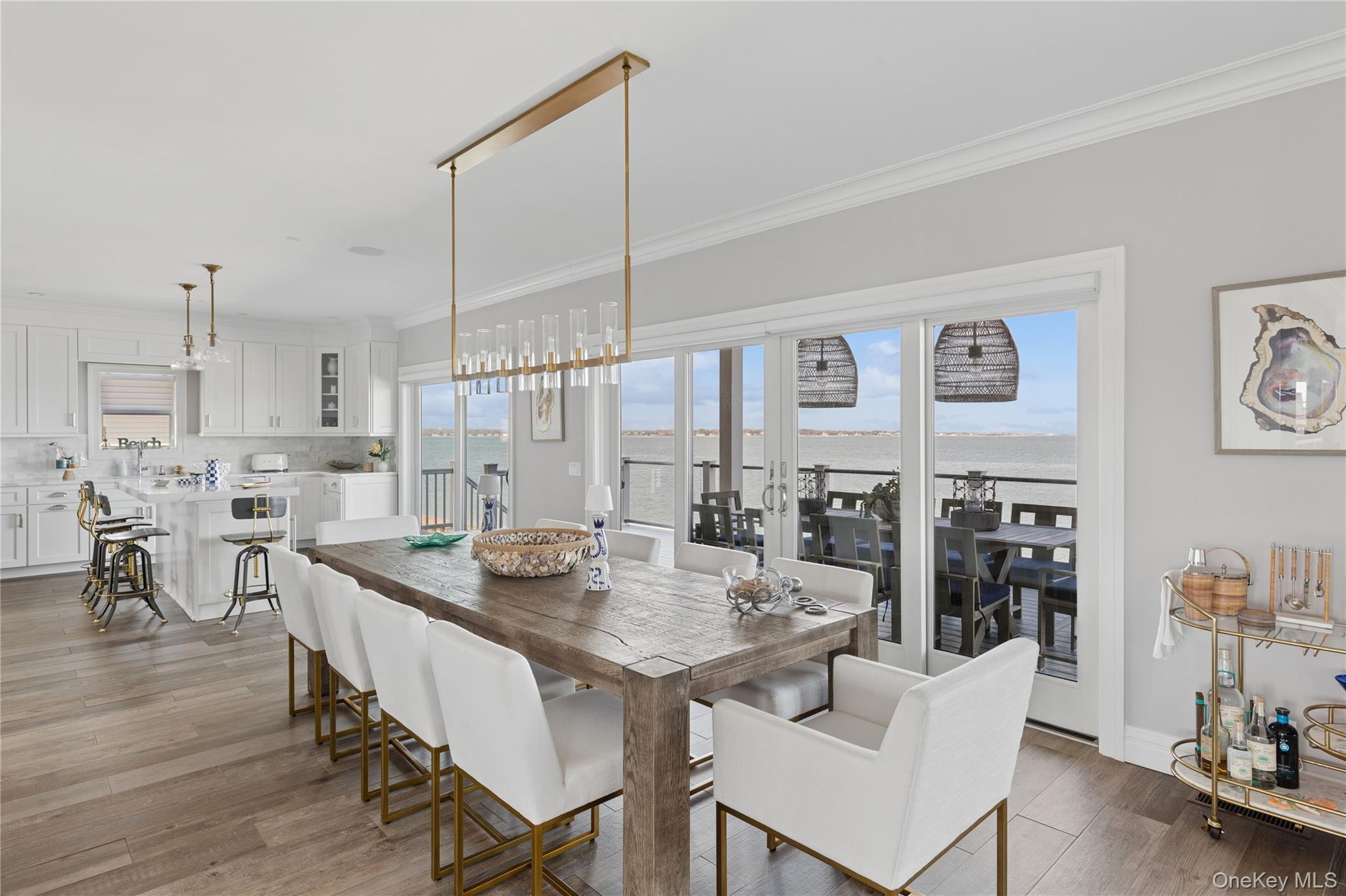 39 Shinnecock Road East Quogue, NY 11942 - Photo 12 of 35 a view of a dining room kitchen and hall with wooden floor