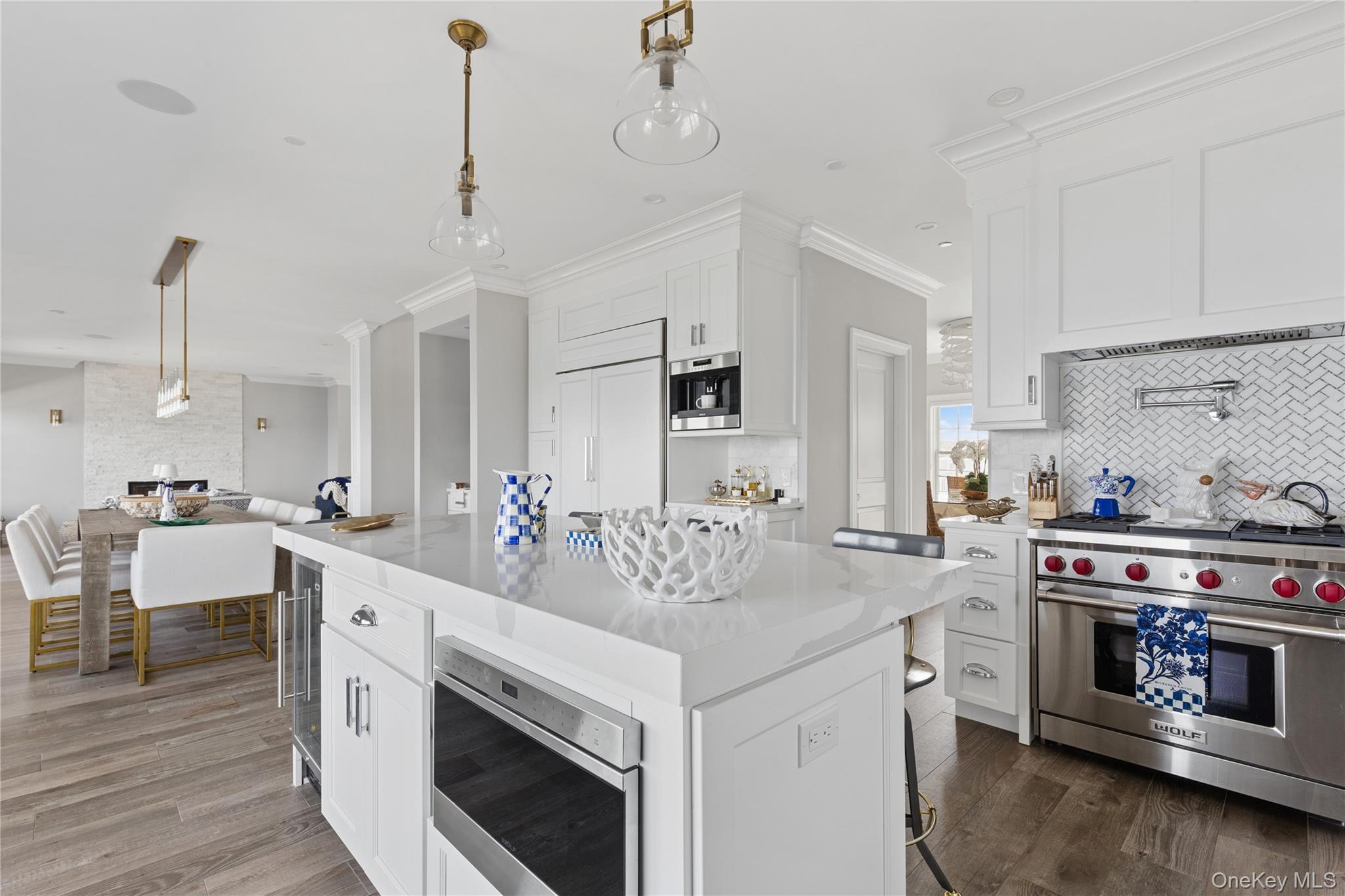 39 Shinnecock Road East Quogue, NY 11942 - Photo 16 of 35 a kitchen with stainless steel appliances granite countertop a stove and a sink