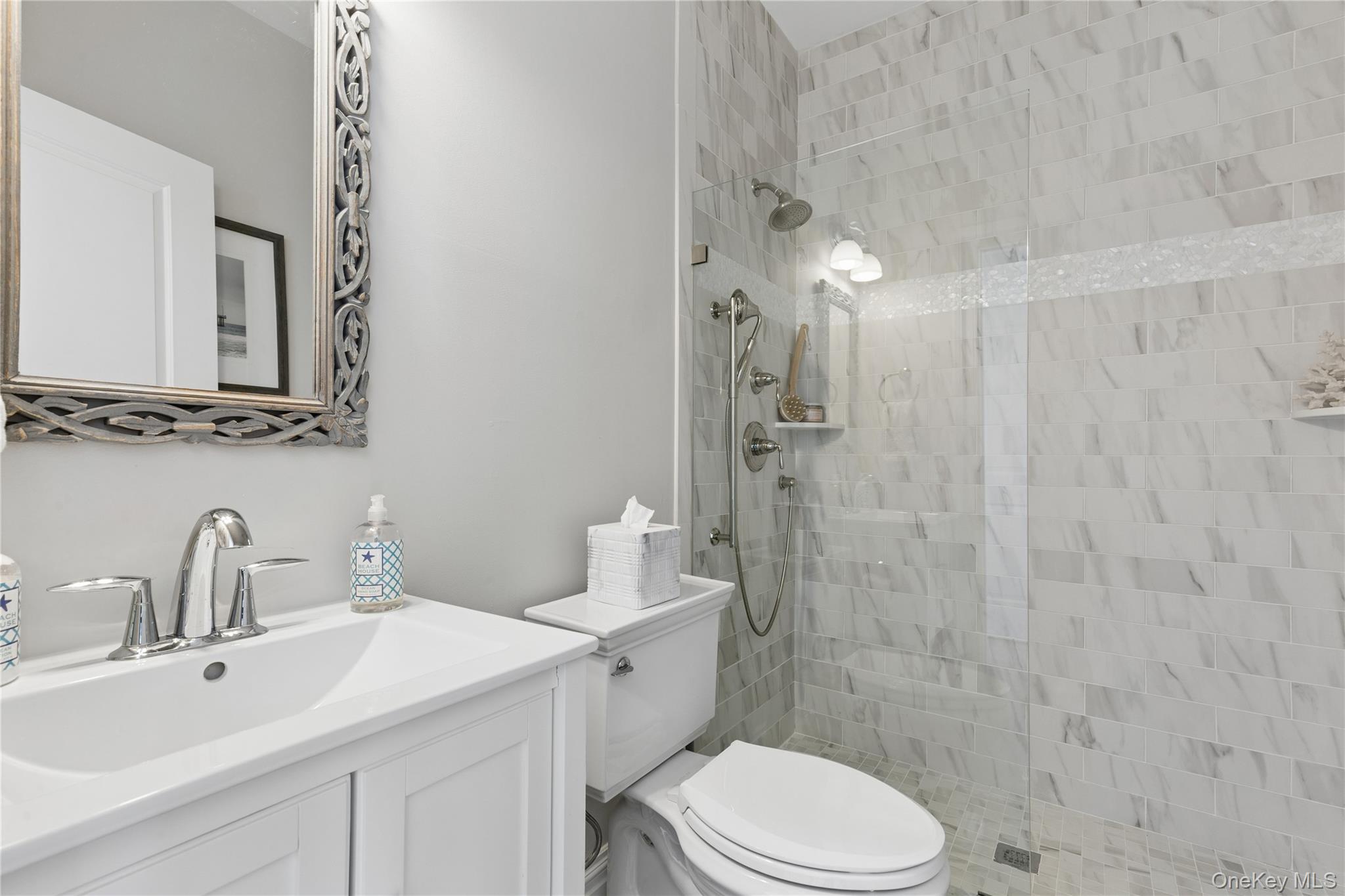 39 Shinnecock Road East Quogue, NY 11942 - Photo 18 of 35 a bathroom with a sink a toilet and shower