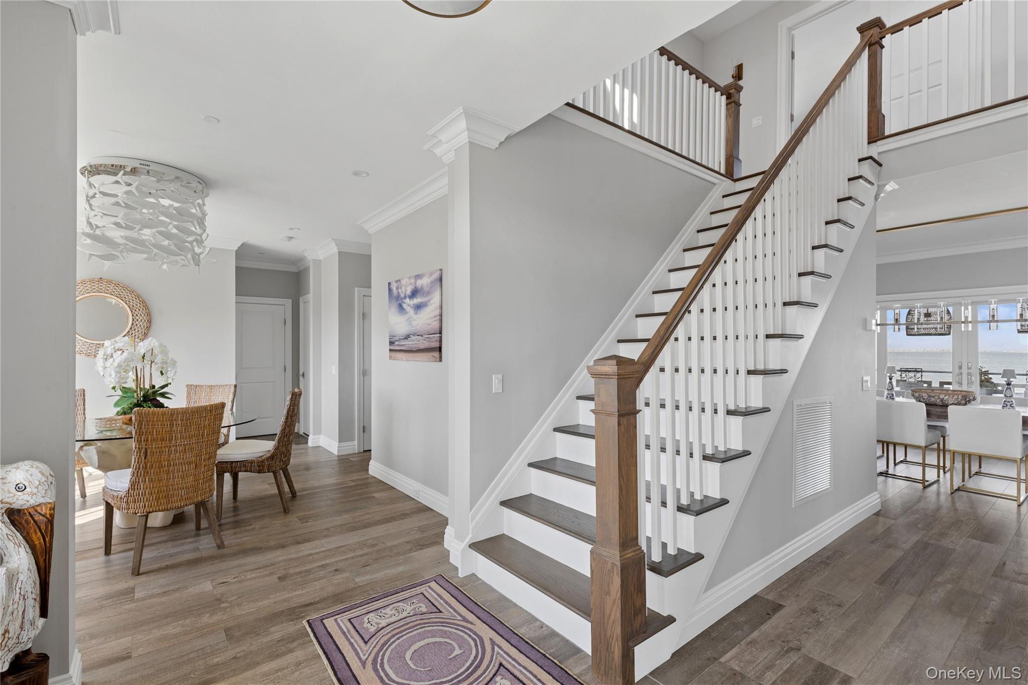 39 Shinnecock Road East Quogue, NY 11942 - Photo 22 of 35 a view of entryway with dining room and wooden floor