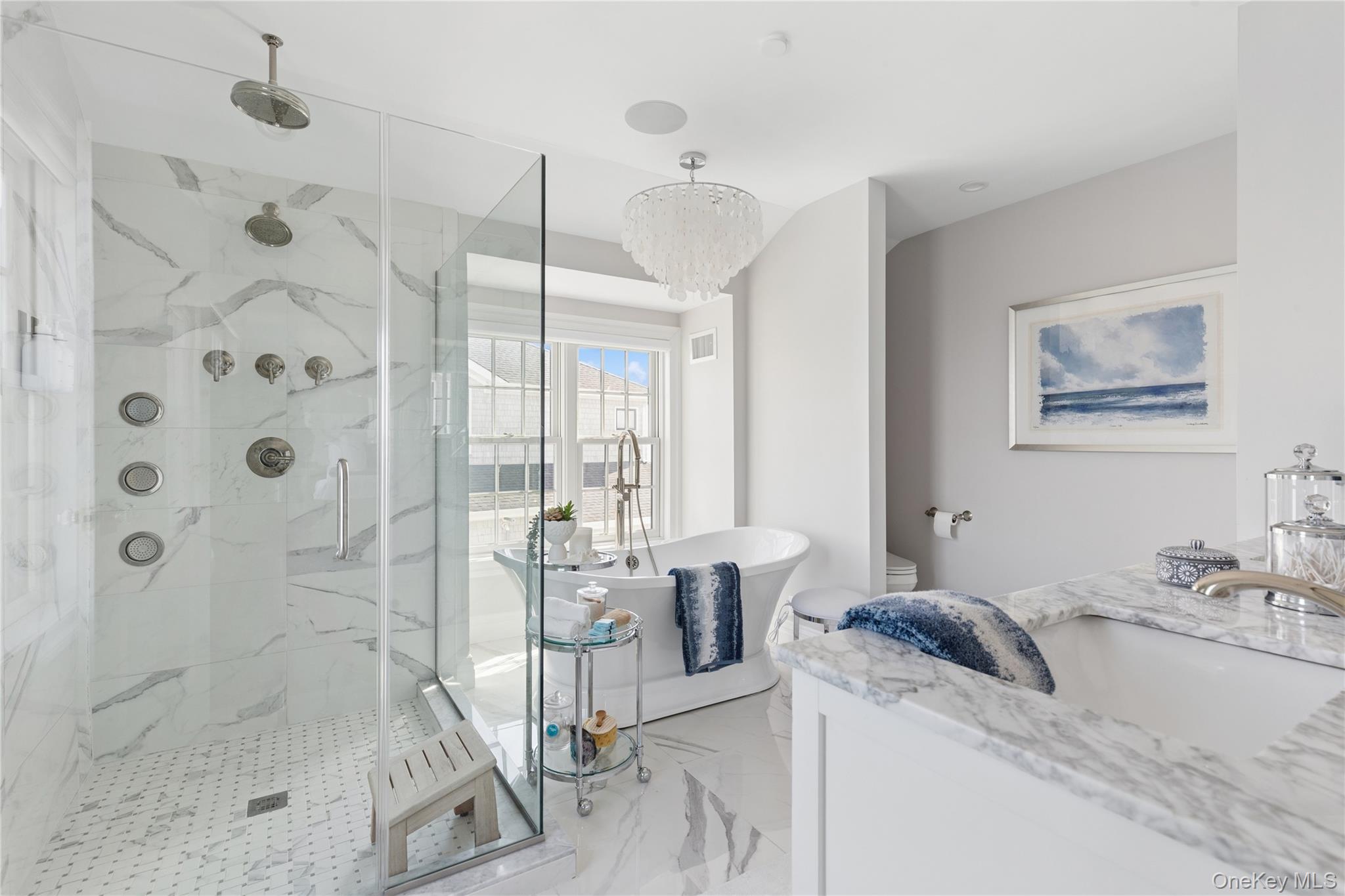 39 Shinnecock Road East Quogue, NY 11942 - Photo 25 of 35 a spacious bathroom with a granite countertop sink a toilet and shower