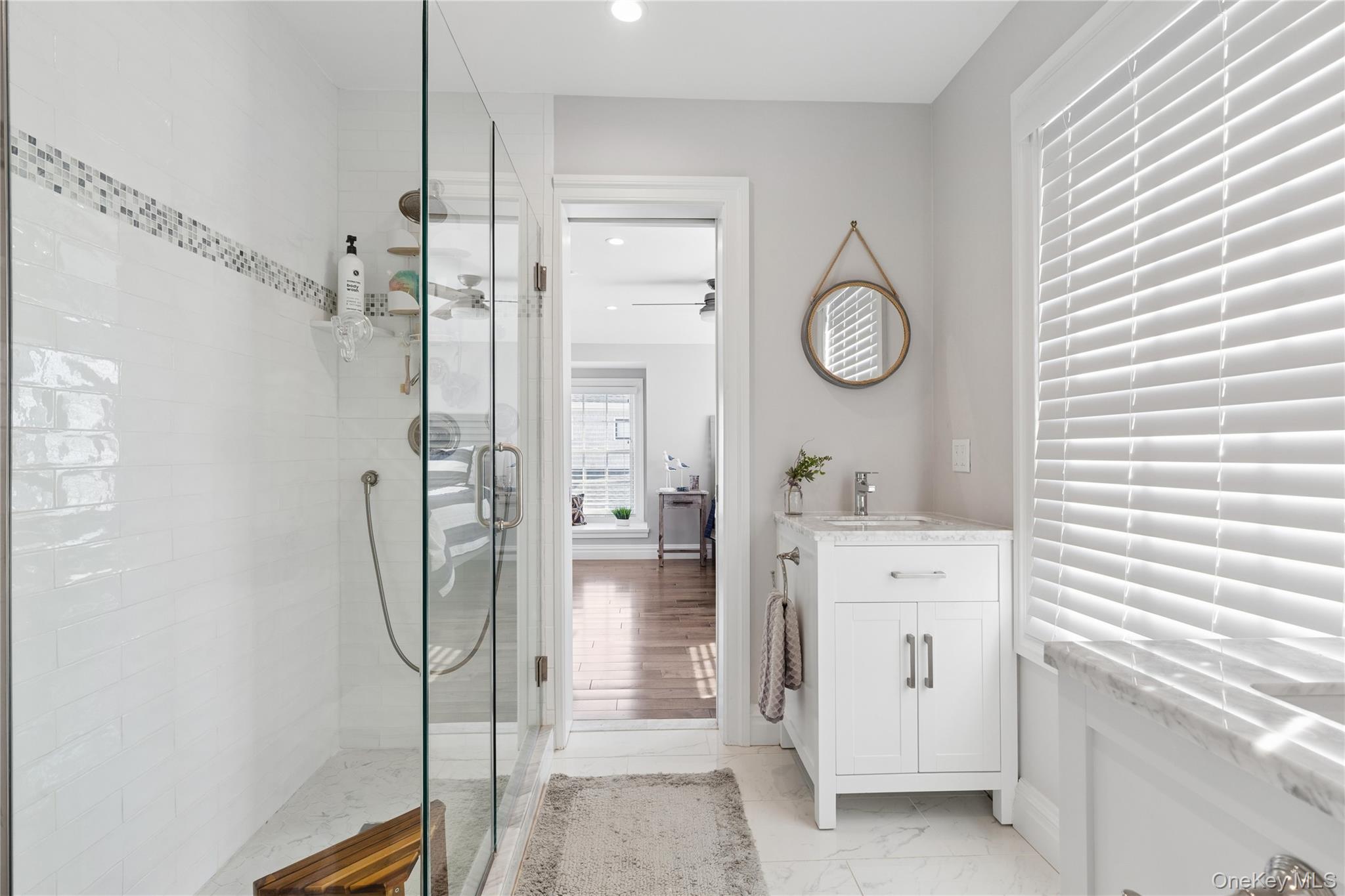 39 Shinnecock Road East Quogue, NY 11942 - Photo 29 of 35 a spacious bathroom with a shower a mirror and a sink