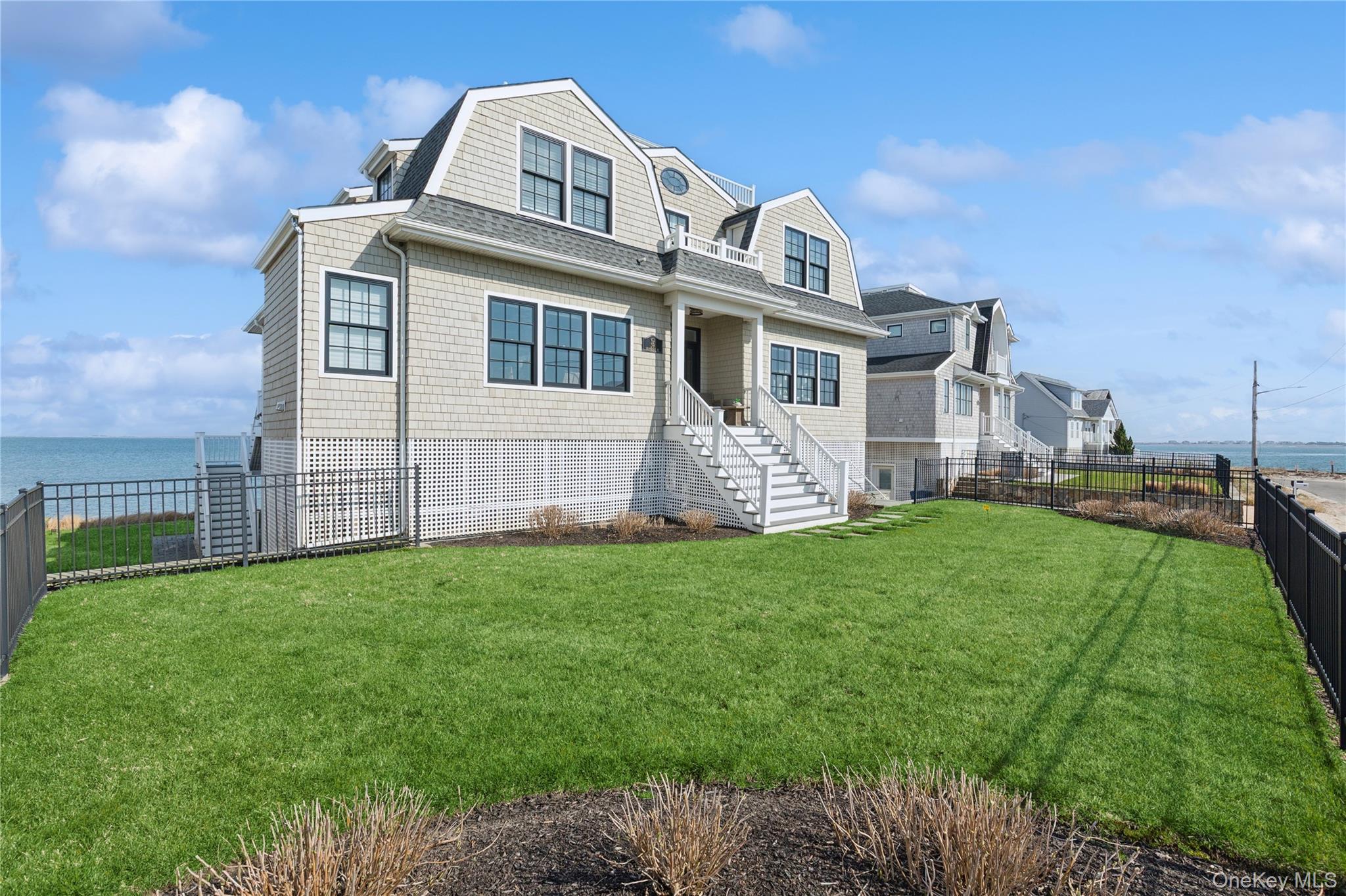39 Shinnecock Road East Quogue, NY 11942 - Photo 35 of 35 a front view of a house with a garden