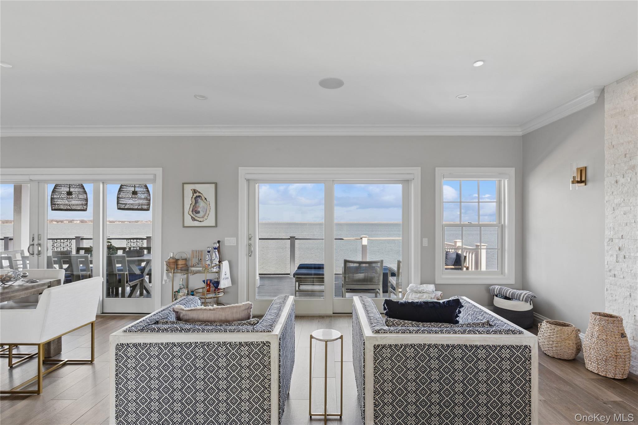 39 Shinnecock Road East Quogue, NY 11942 - Photo 6 of 35 a living room with furniture a rug a fireplace and windows