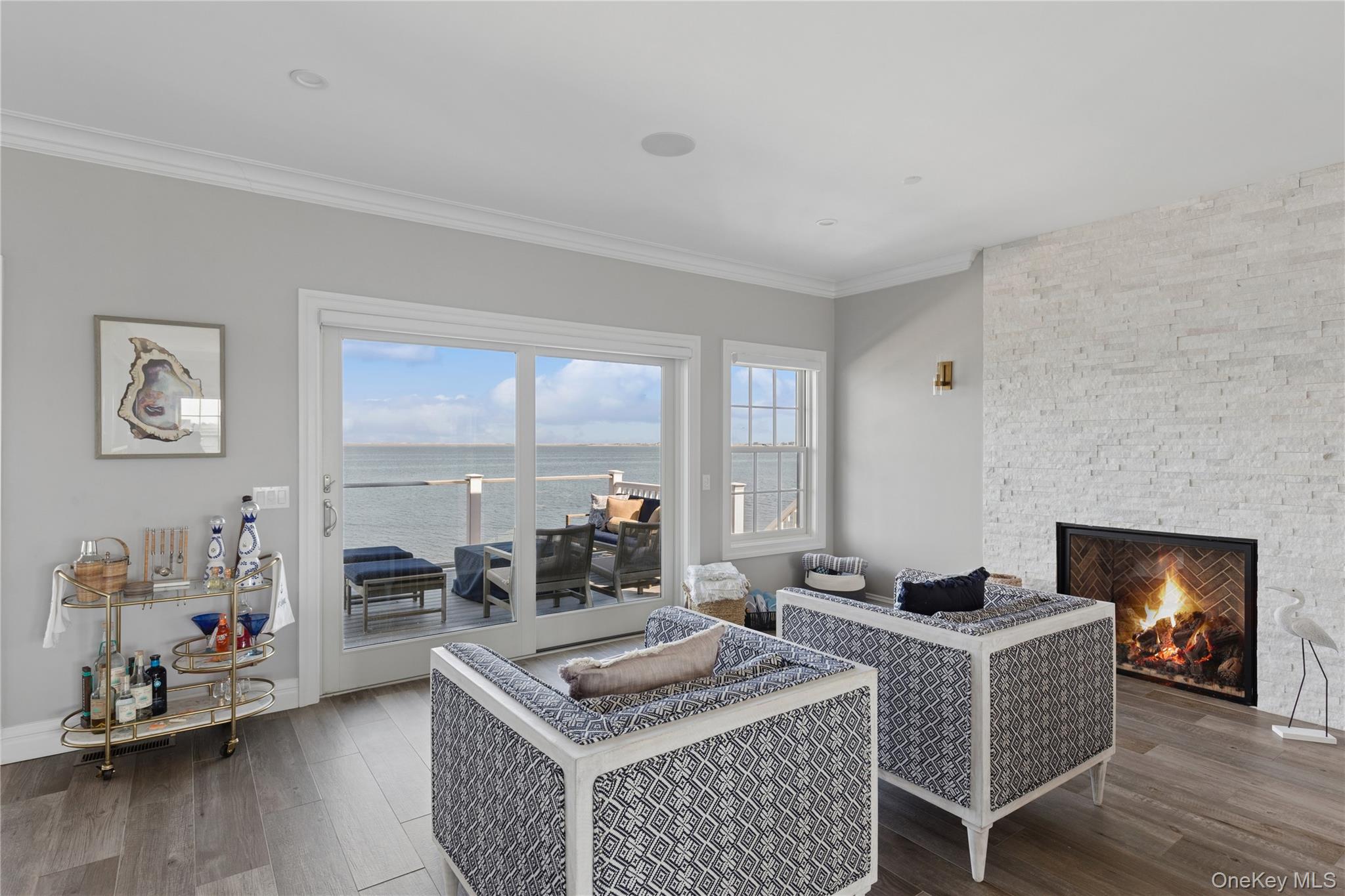 39 Shinnecock Road East Quogue, NY 11942 - Photo 7 of 35 a living room with furniture and a fireplace
