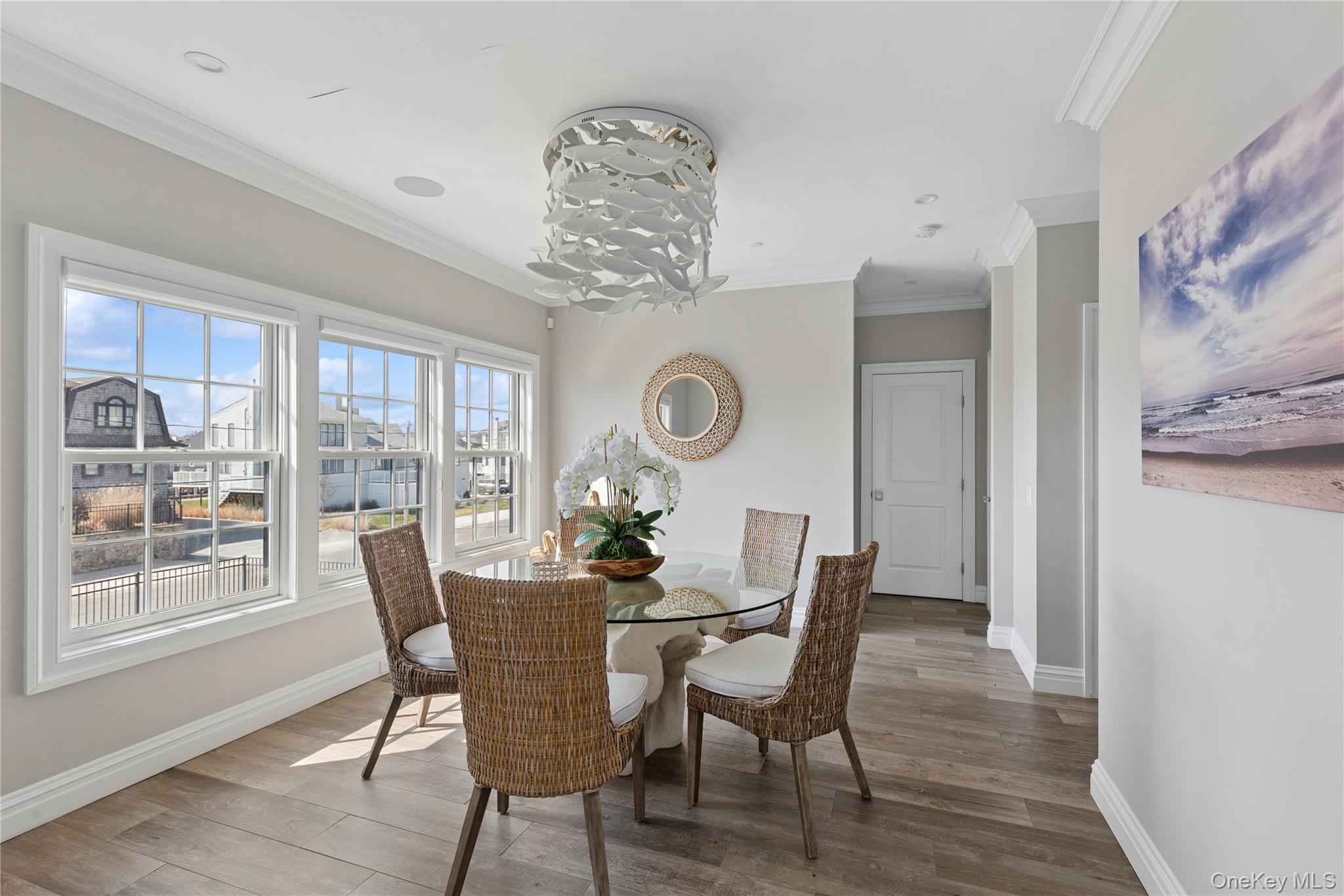 39 Shinnecock Road East Quogue, NY 11942 - Photo 10 of 35 a dining room with furniture a rug and a painting