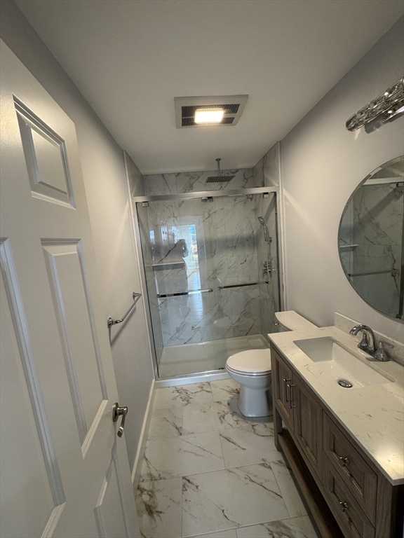 41 Westminster Street Worcester, MA 01605 - Photo 20 of 32 a bathroom with a double vanity sink toilet mirror and shower