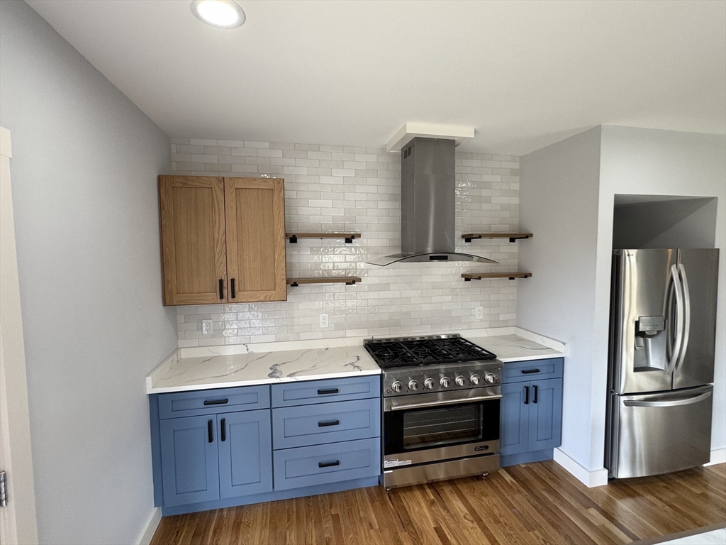 41 Westminster Street Worcester, MA 01605 - Photo 10 of 32 a kitchen with stainless steel appliances granite countertop a stove and a refrigerator