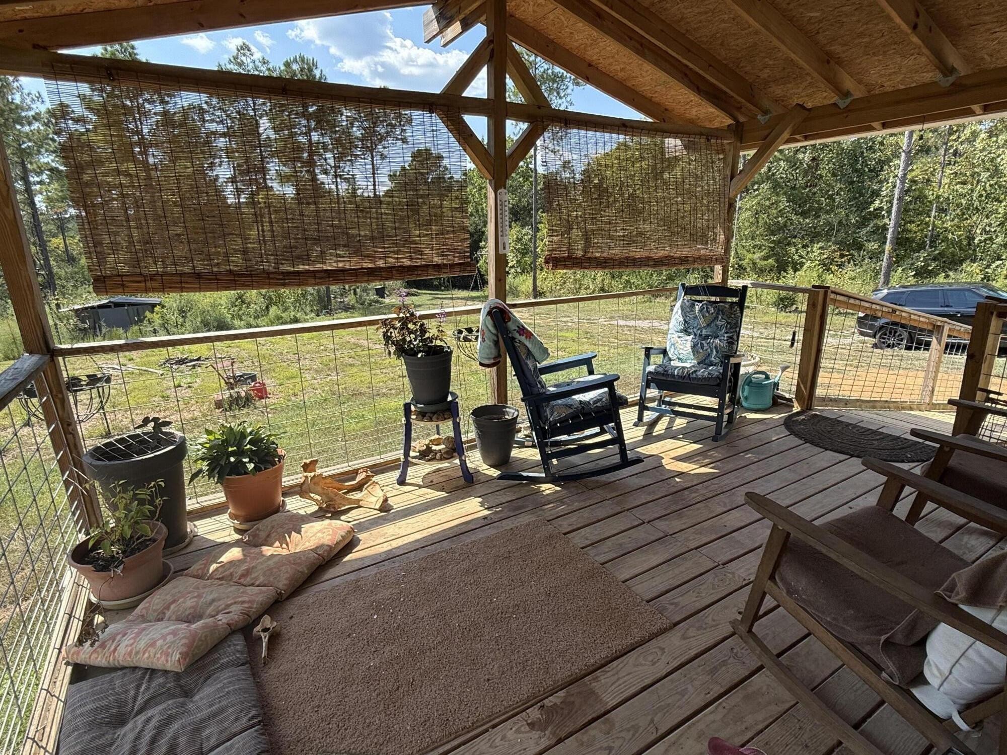 145 Pinhook Road Calhoun, TN 37309 - Photo 5 of 30 a view of a patio with table and chairs next to a yard
